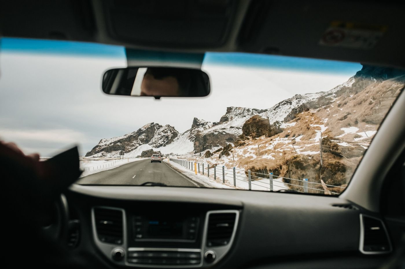 A mountain highway seen through a car windscreen